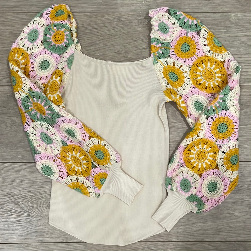 Cream colored top with floral crochet sleeves